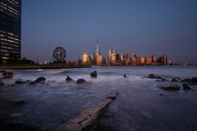 View of city buildings against clear sky