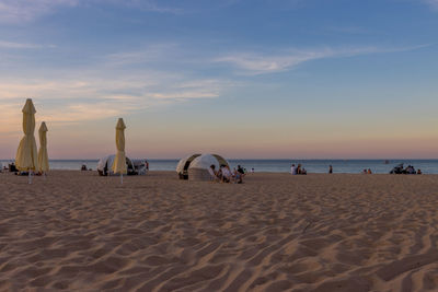 Scenic view of beach against sky during sunset