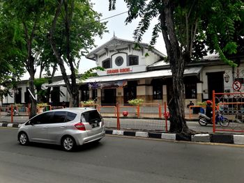 Cars on street by buildings in city