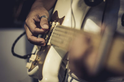 Cropped hand playing guitar