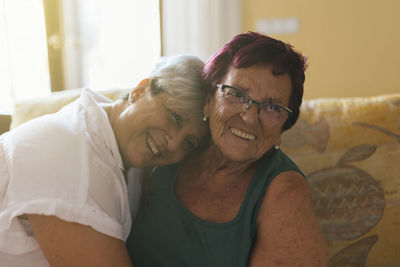 Happy daughter enjoying leisure time with mother at home