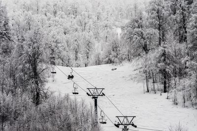 Ski lift on field during winter