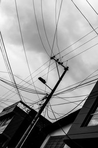 Low angle view of cables against sky