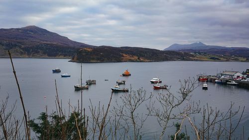 High angle view of boats in sea against cloudy sky