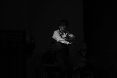 Young woman standing against gray background