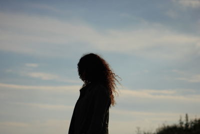 Side view of a girl against the sky
