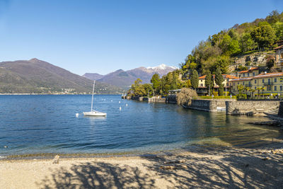 The colmegna coast in the lake maggiore with its beach and its villas