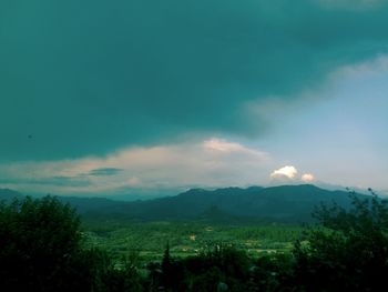 Scenic view of mountains against cloudy sky