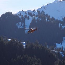 Scenic view of helicopter and mountains against sky