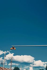 Low angle view of street light against blue sky