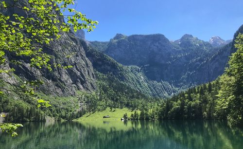 Scenic view of lake and mountains against sky