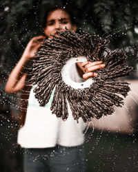 Portrait of young woman spinning a water object