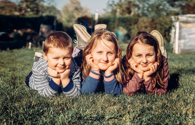 Happy friends lying on grass