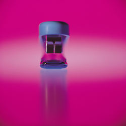 Close-up of stapler on pink background