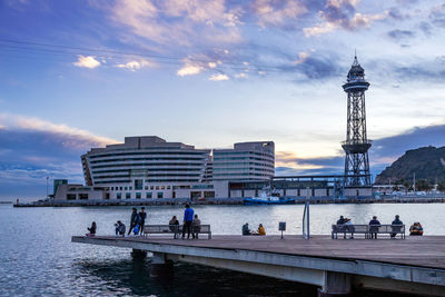 People on the river with buildings in background