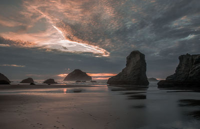 Scenic view of sea against sky during sunset with rock stacks