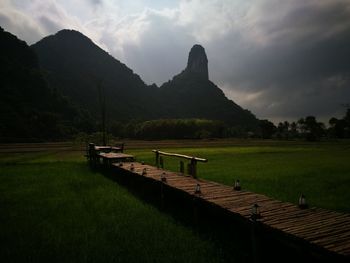 Scenic view of land and mountains against sky