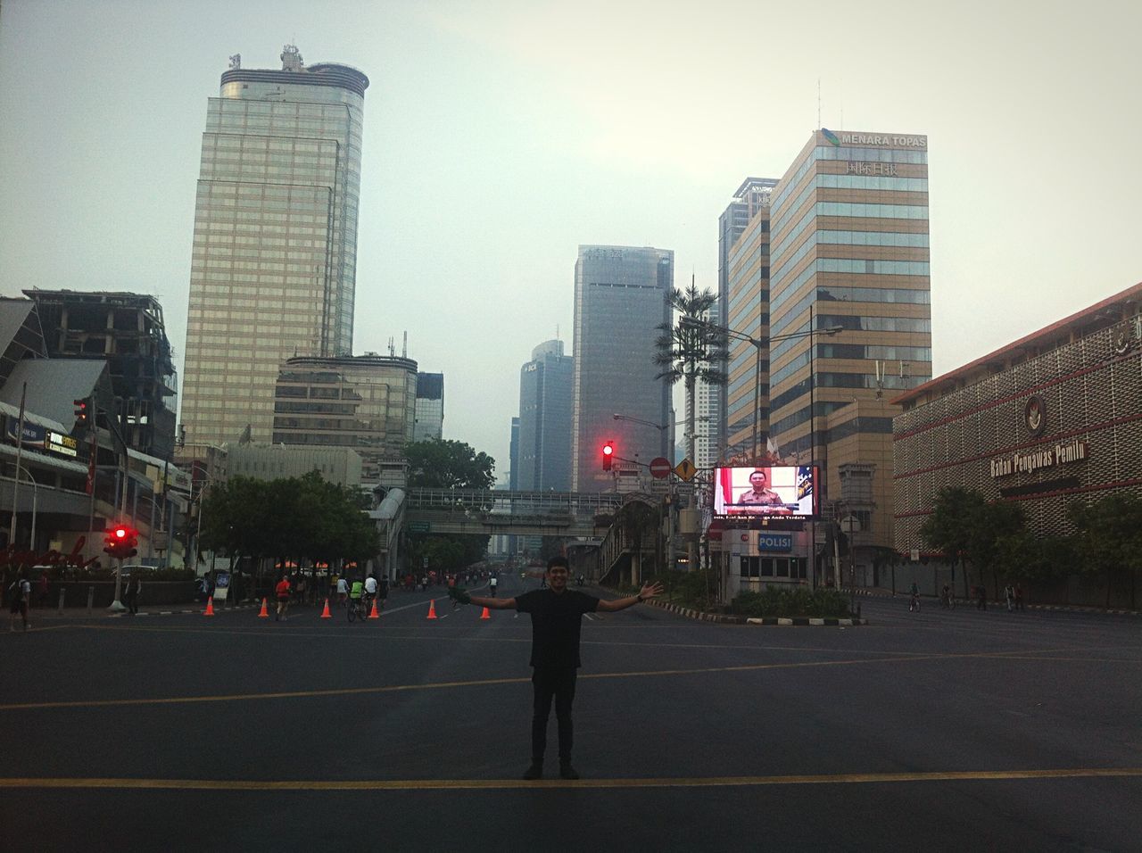 building exterior, architecture, city, built structure, transportation, street, city life, road, skyscraper, men, office building, road marking, city street, modern, zebra crossing, walking, tall - high, tower