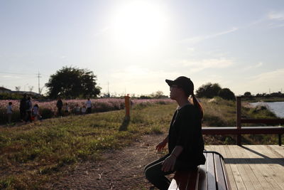 Side view of woman against sky