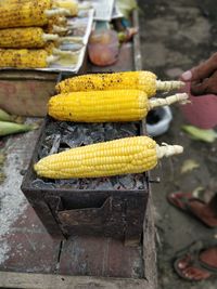 High angle view of yellow corn on bbq for sale in market