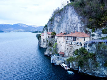 Drone view at the monastery of santa caterina del sasso on lake maggiore italy