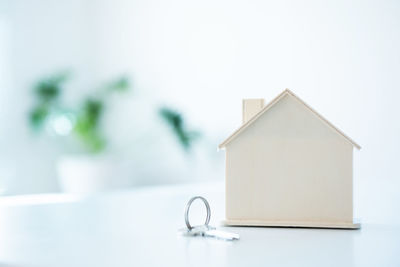 Close-up of white house on table against building