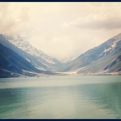 Scenic view of lake against cloudy sky