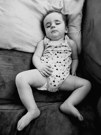 High angle view of baby relaxing on bed