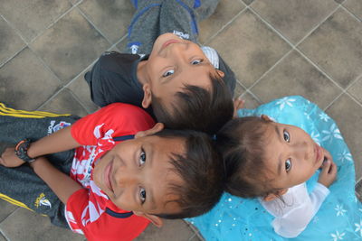 High angle portrait of cute boy and daughter on floor