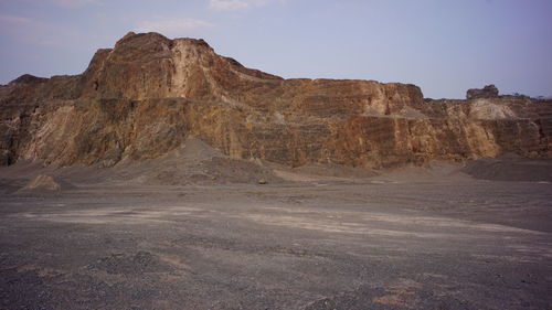 Rock formations on landscape against sky