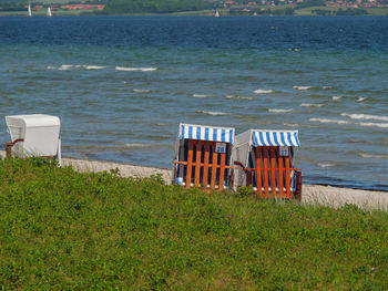 Chairs on beach by sea