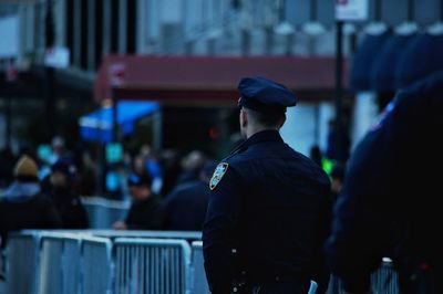 Rear view of people looking at city