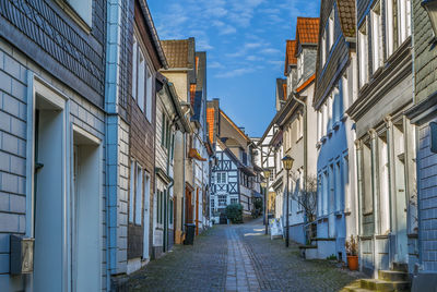 Narrow alley amidst buildings in city