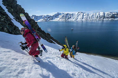 Group of friends skinning up mountain to ski in svalbard