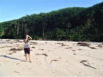 Full length of woman standing at beach