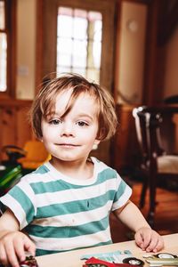 Portrait of cute boy sitting on table