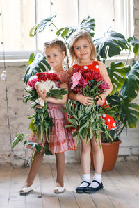 Portrait of girl holding flower pot