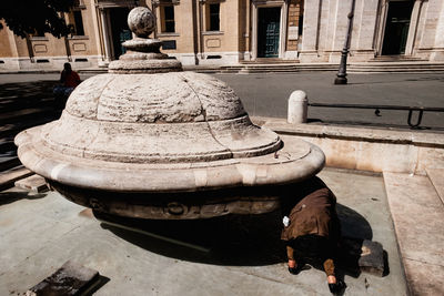 Rear view of woman walking by steps