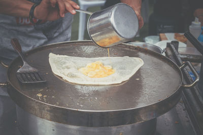 Midsection of man preparing food at market stall