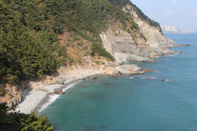 Scenic view of sea and mountains against sky