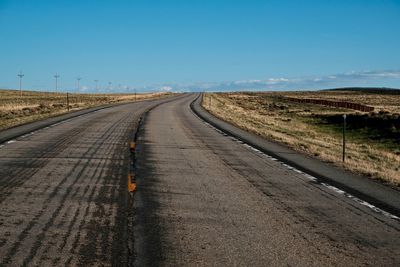 Road amidst landscape against clear sky