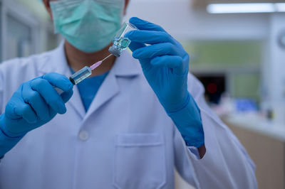 Midsection of person holding umbrella