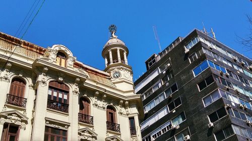 Low angle view of buildings against blue sky