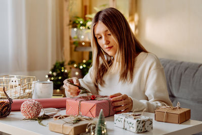 Portrait of smiling woman sitting at home