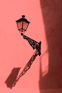 Low angle view of street light against wall