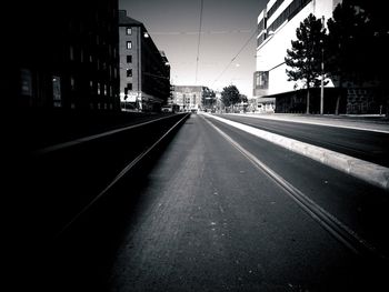 Empty road along buildings