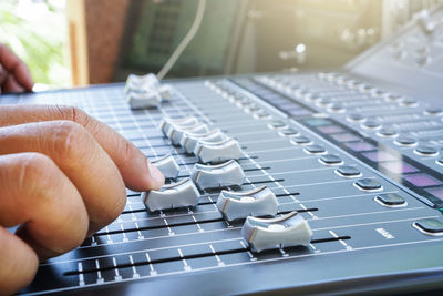 Close-up of person using sound mixer
