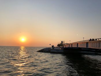 Scenic view of sea against orange sky