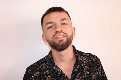 Portrait of young man against white background