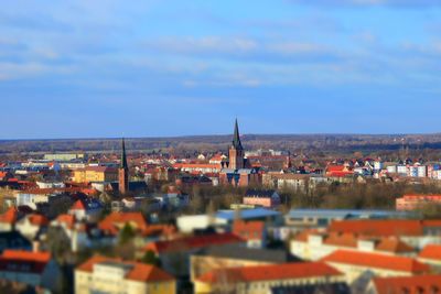 View of cityscape against blue sky